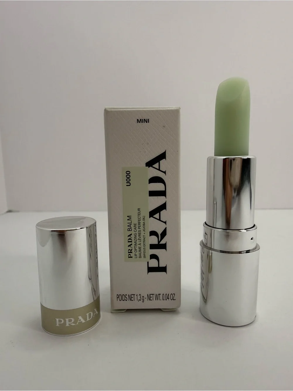 Prada Mini Lip Balm Universal U000- Green goes on clear